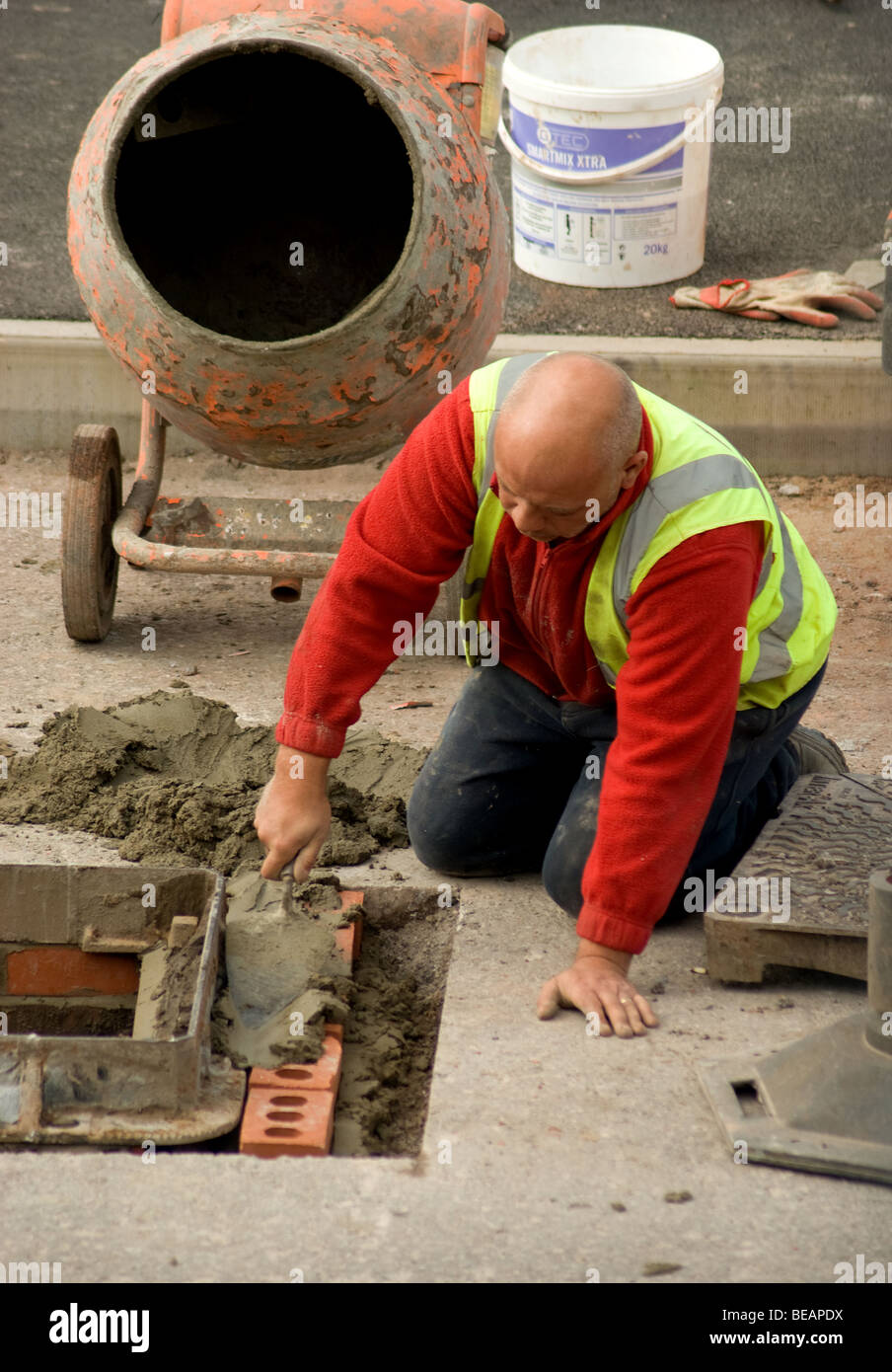 Roadworker working on drainage Stock Photo
