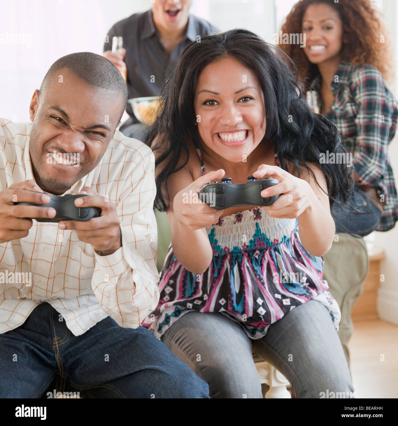 Man and woman playing video game and making faces Stock Photo