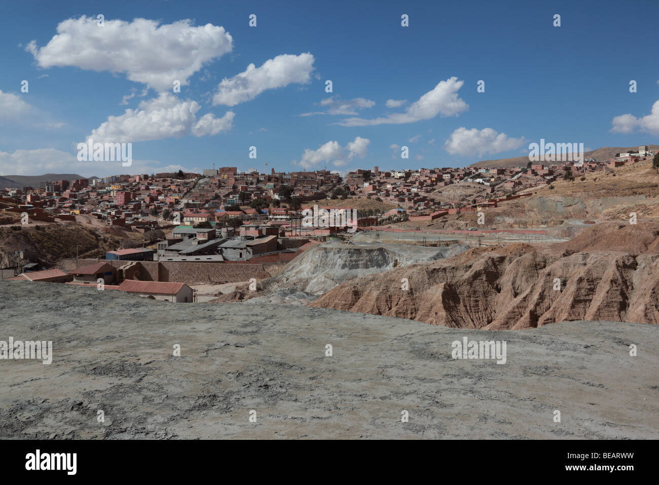 Tailings waste from nearby mines on outskirts of Potosi, suburbs of city in background, Bolivia Stock Photo