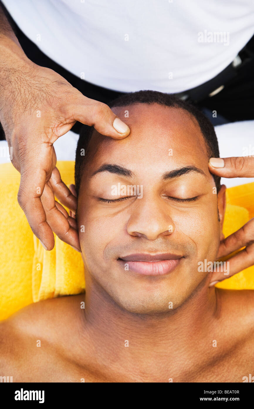 Mixed race man receiving head massage Stock Photo Alamy