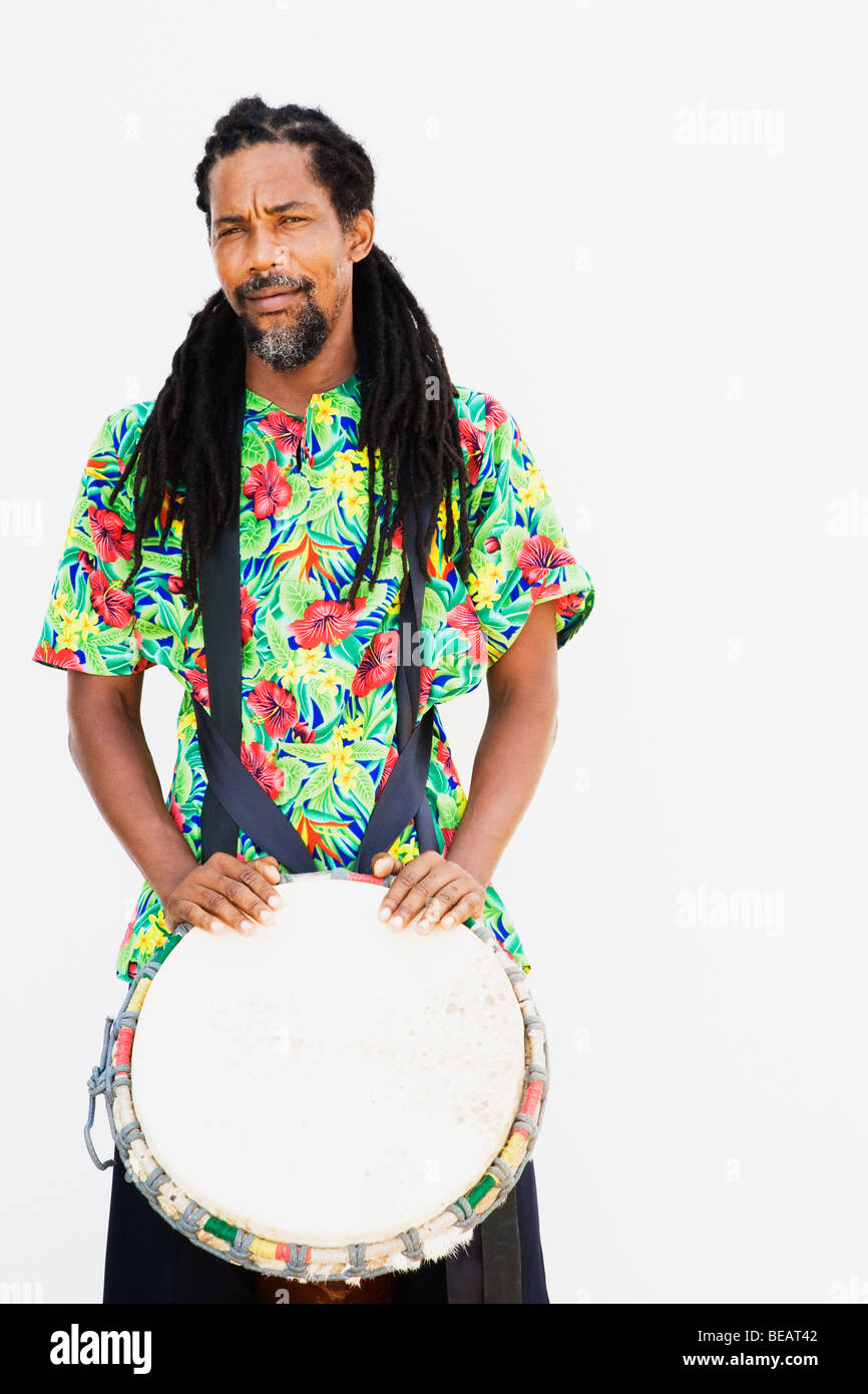 African man holding drum Stock Photo - Alamy