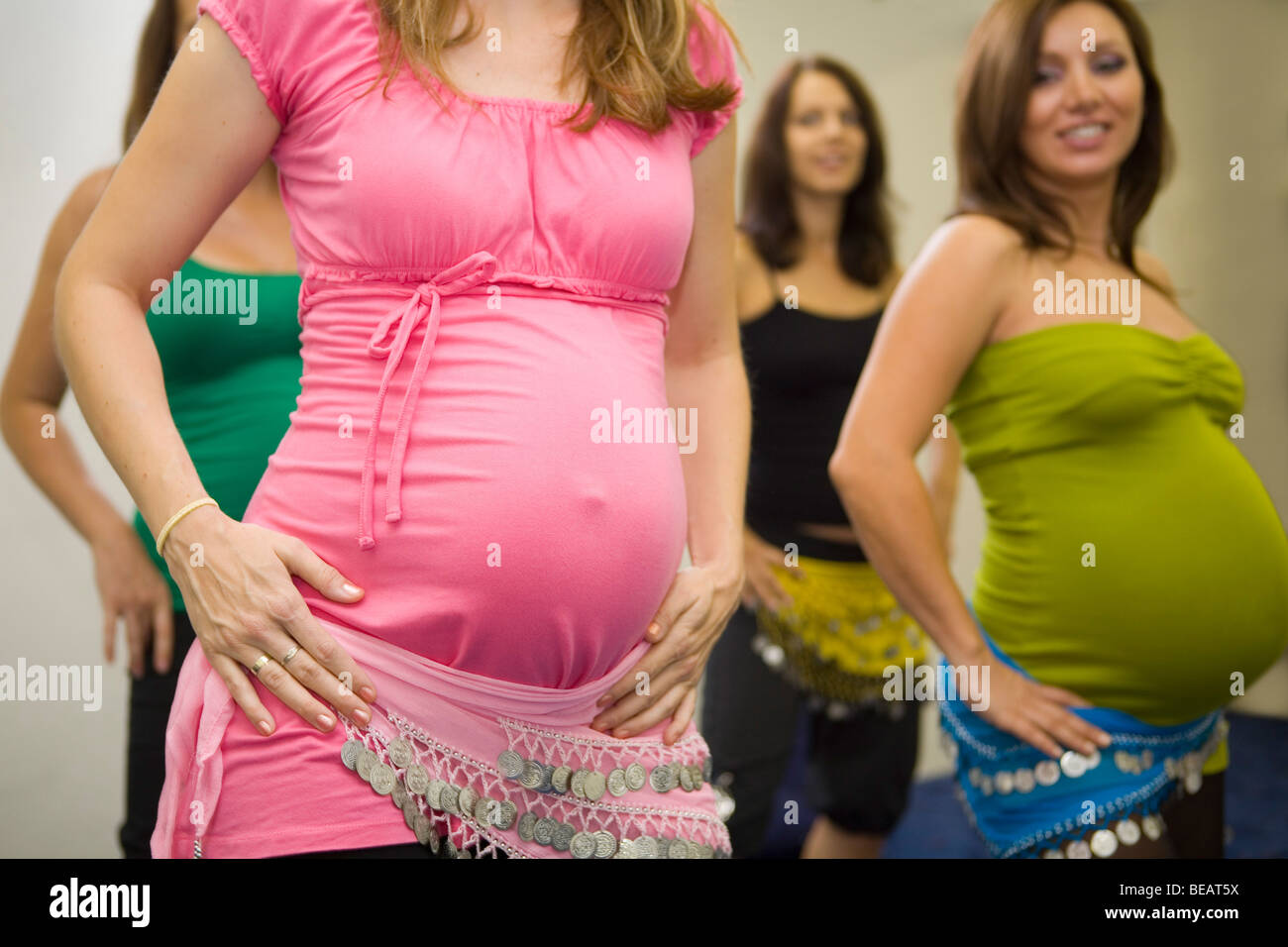 Pregnant women dancing belly dance. Stock Photo