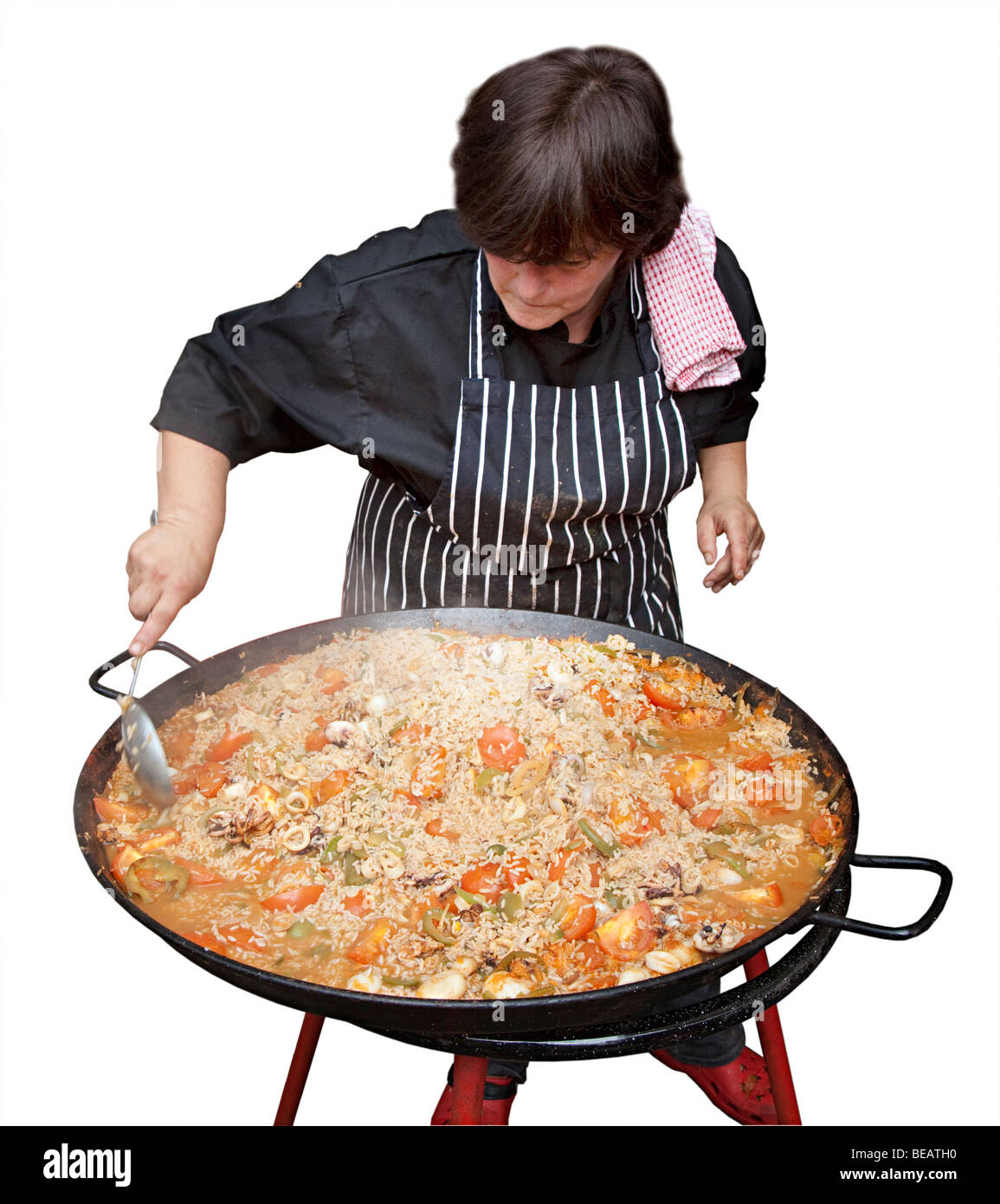 https://c8.alamy.com/comp/BEATH0/woman-cooking-paella-in-large-metal-pan-BEATH0.jpg