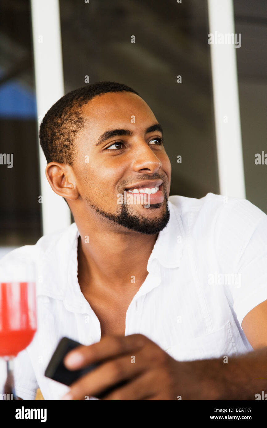 African man holding cell phone Stock Photo Alamy