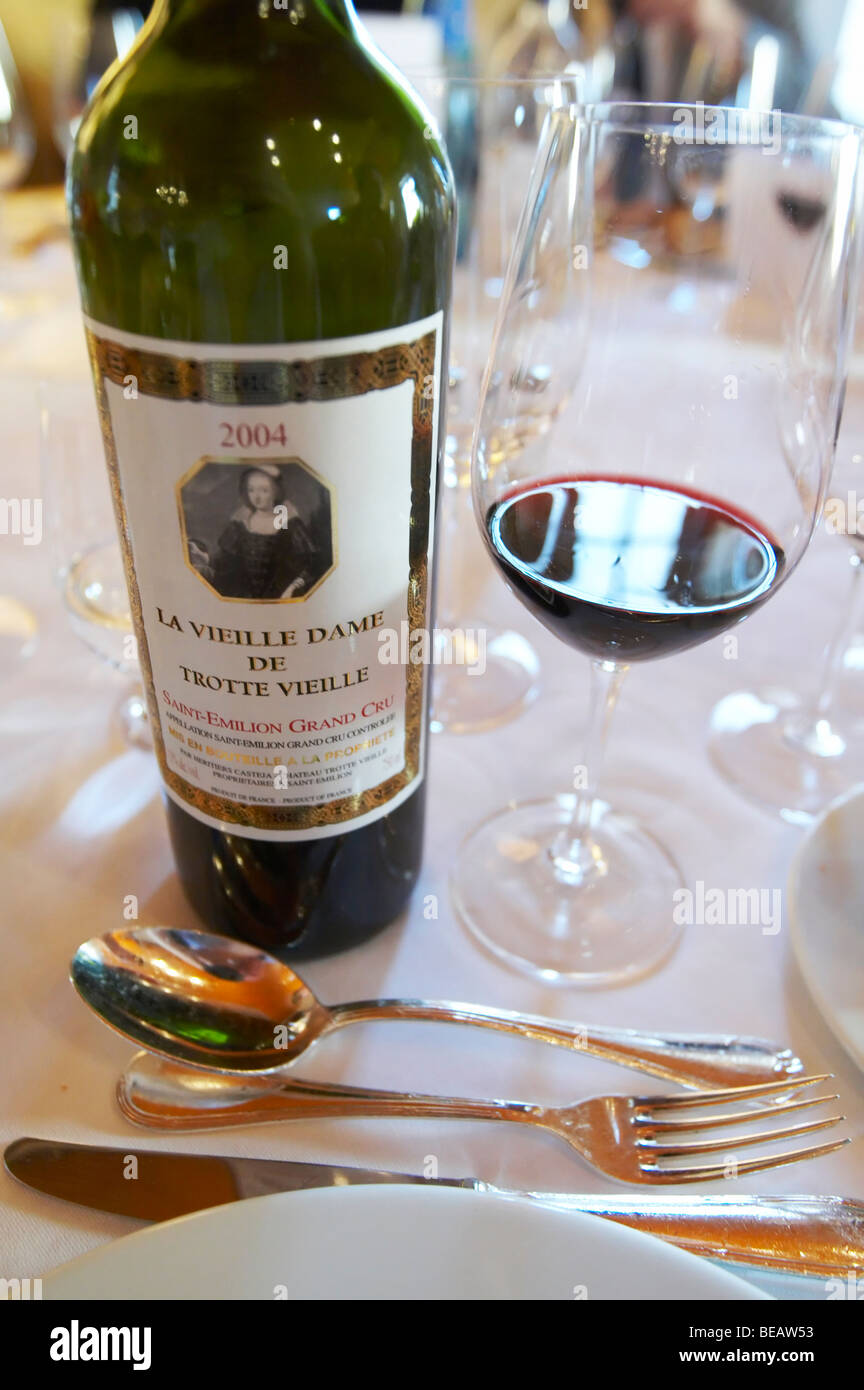 bottle and glass with wine at dinner table la vieille dame de chateau trottevieille saint emilion bordeaux france Stock Photo
