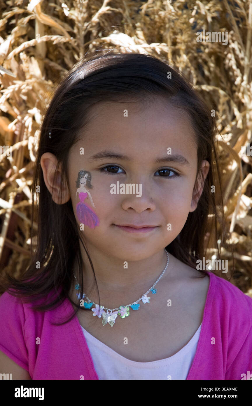 A Young Girl With A Small Face Painting At A Fall Harvest Festival