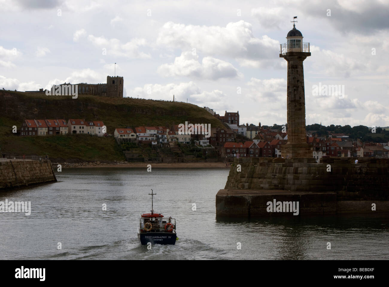 A boat entering the harbour at Whitby, North Yorkshire, England Stock ...