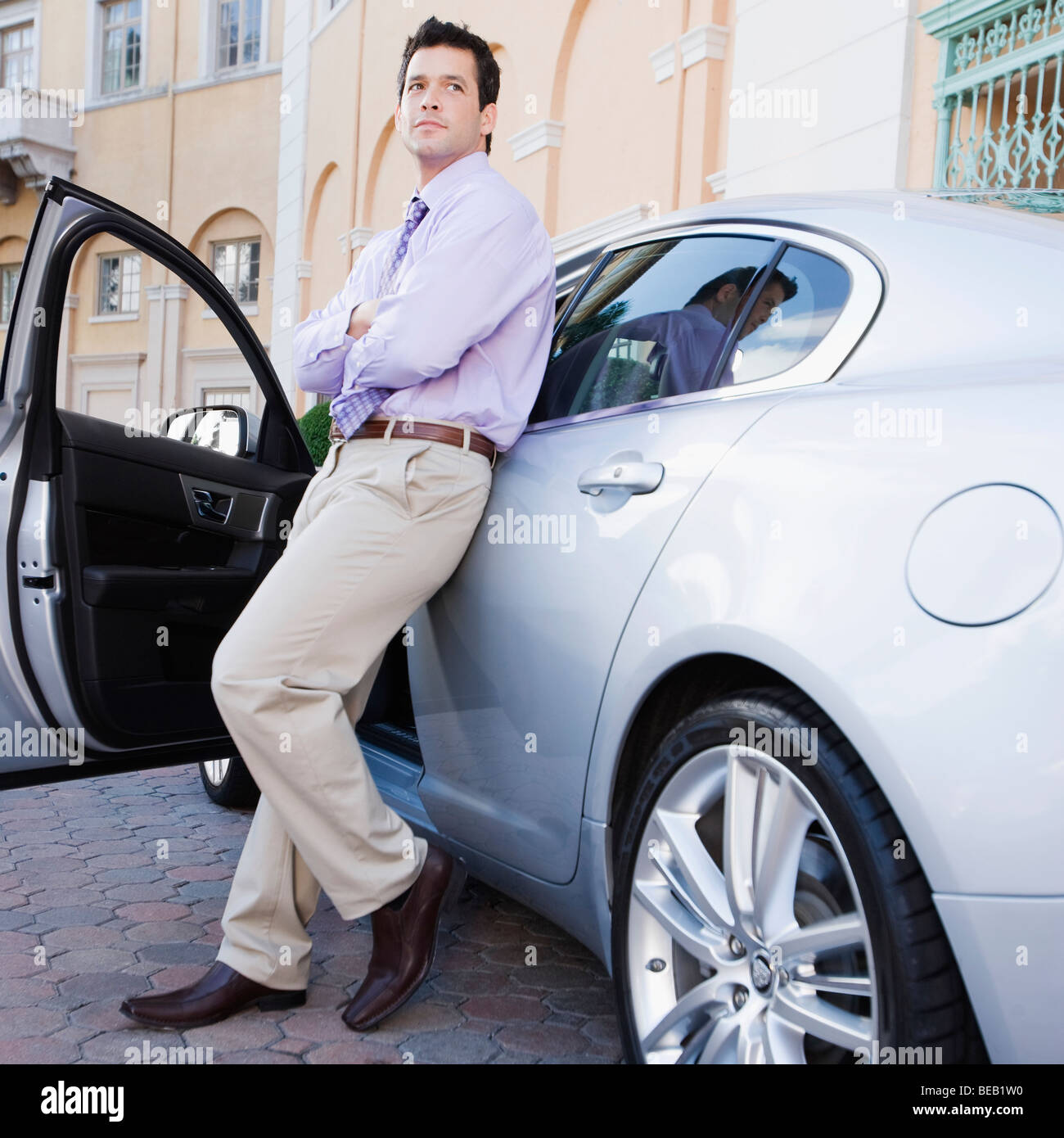 Businessman leaning against a car, Biltmore Hotel, Coral Gables, Florida, USA Stock Photo