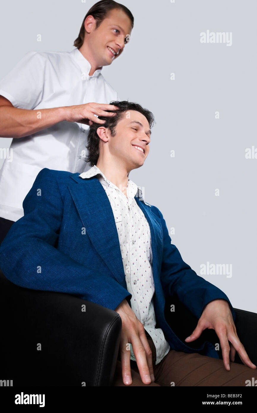 Barber massaging a man's head Stock Photo