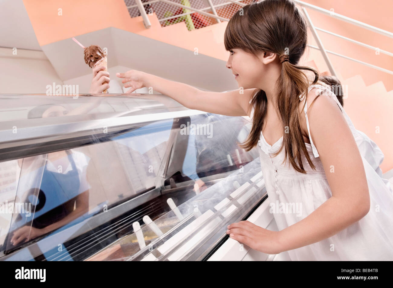 Female ice cream seller giving ice cream to a customer Stock Photo Alamy