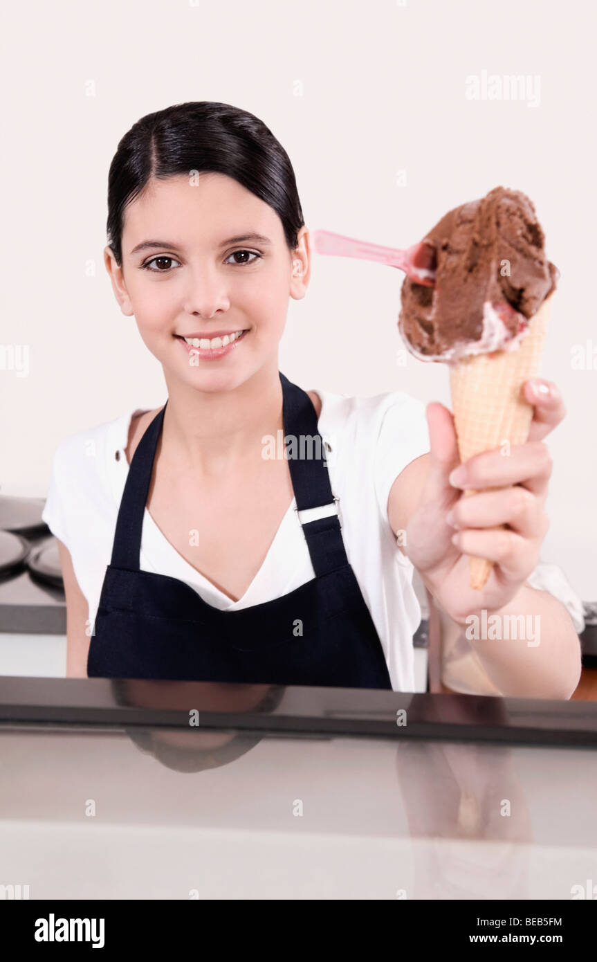 Female ice cream seller holding an ice cream cone Stock Photo Alamy