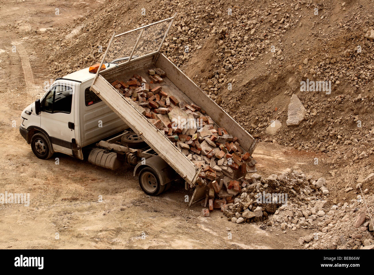 Small truck dumping a load of used bricks Stock Photo Alamy