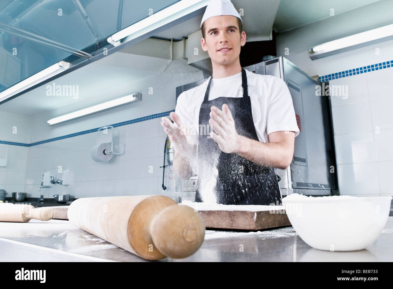 Chef dusting hands with flour Stock Photo Alamy