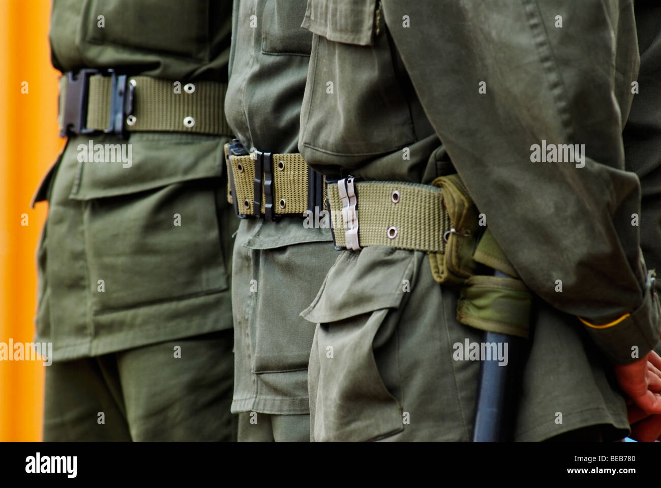 Mid section view of three policemen standing in a row Stock Photo - Alamy