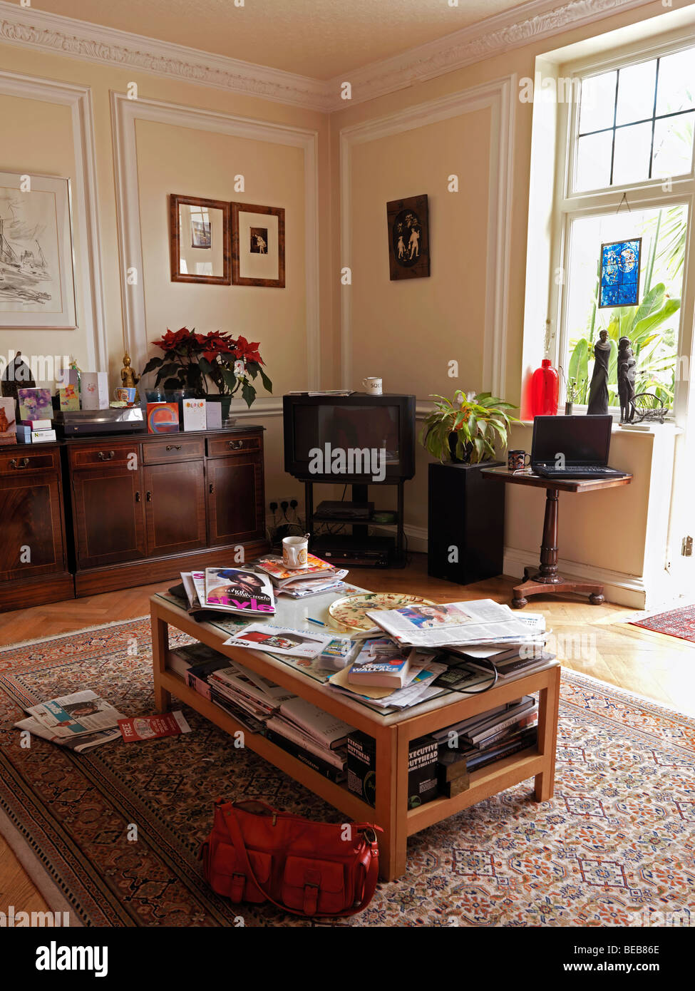 Messy Lounge with Cups Handbag Newspapers Magazine Stock Photo