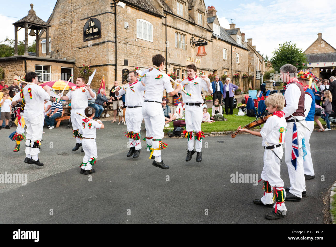 The Chipping Campden Morris Men dancing in front of the Bell Inn in the Cotswold village of Willersey, Gloucestershire Stock Photo