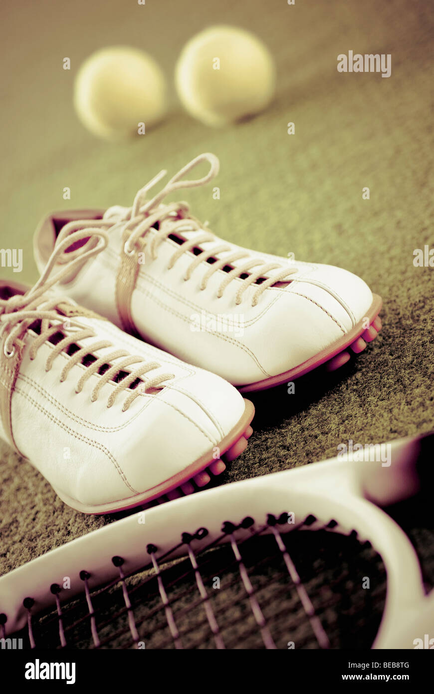 Close-up of a pair of shoes with a tennis racket and tennis balls Stock ...