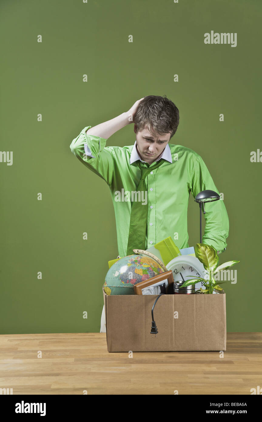 Fired businessman with his office belongings Stock Photo