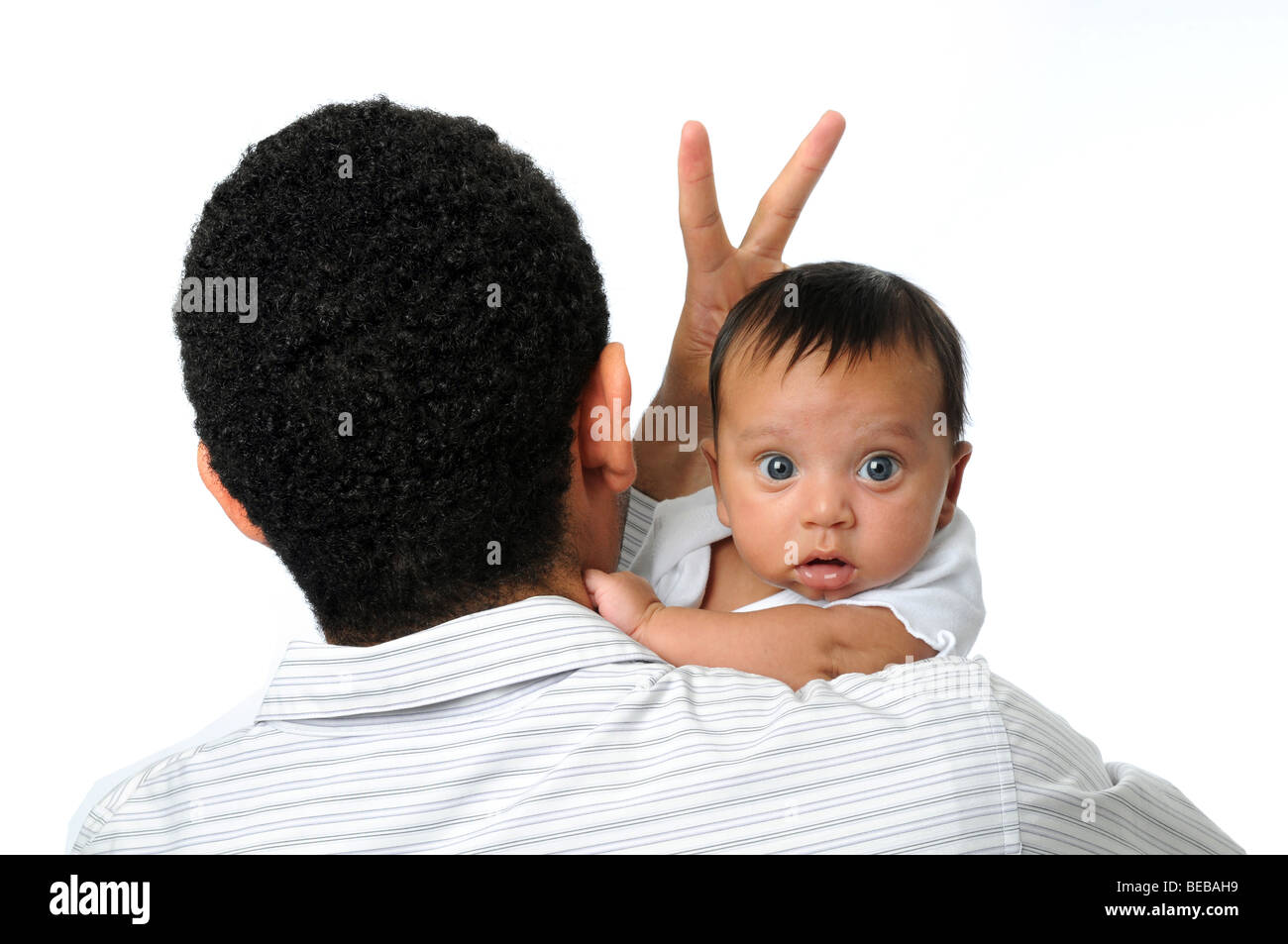 Father giving child rabbit's ears isolated over a white background ...