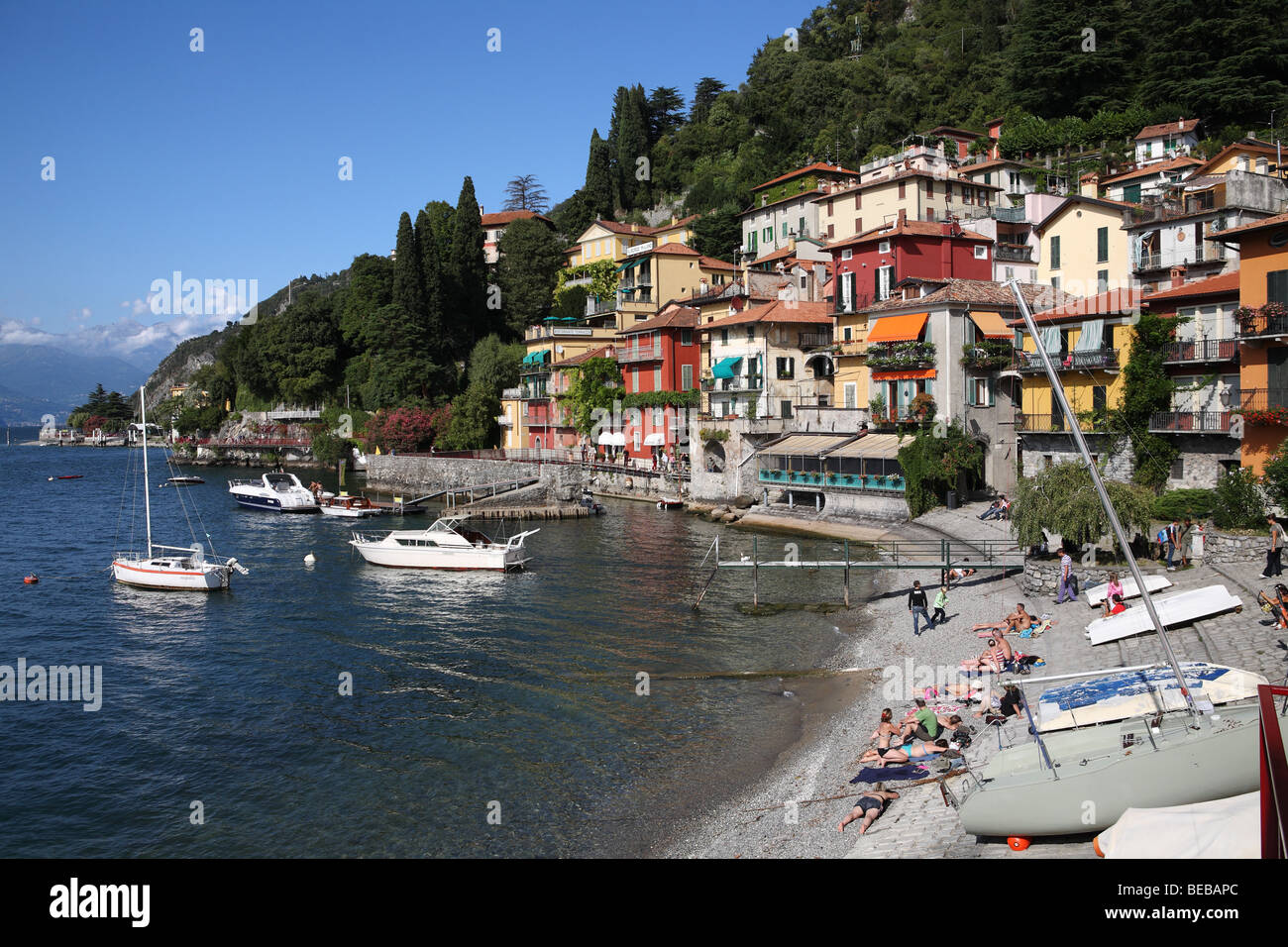 People sunbathing on the beach at Varenna on Lake Como, Italy, Europe Stock Photo