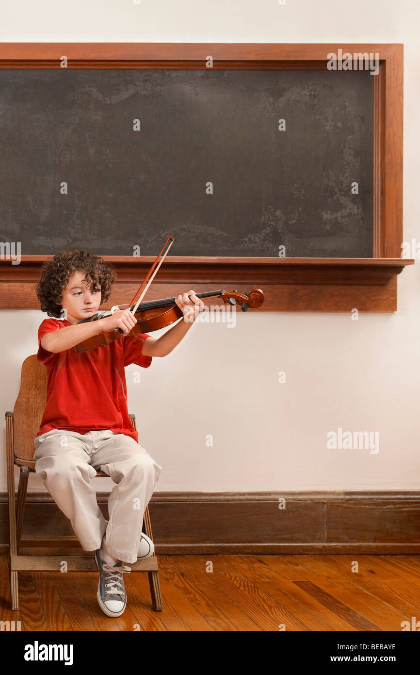 Schoolboy playing a violin in a classroom Stock Photo - Alamy