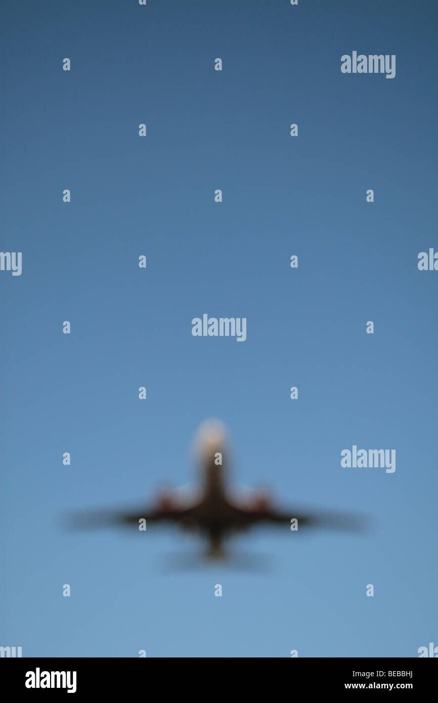 An out of focus image of a plane coming in to land on the South Runway at London's Heathrow Airport, UK. Stock Photo