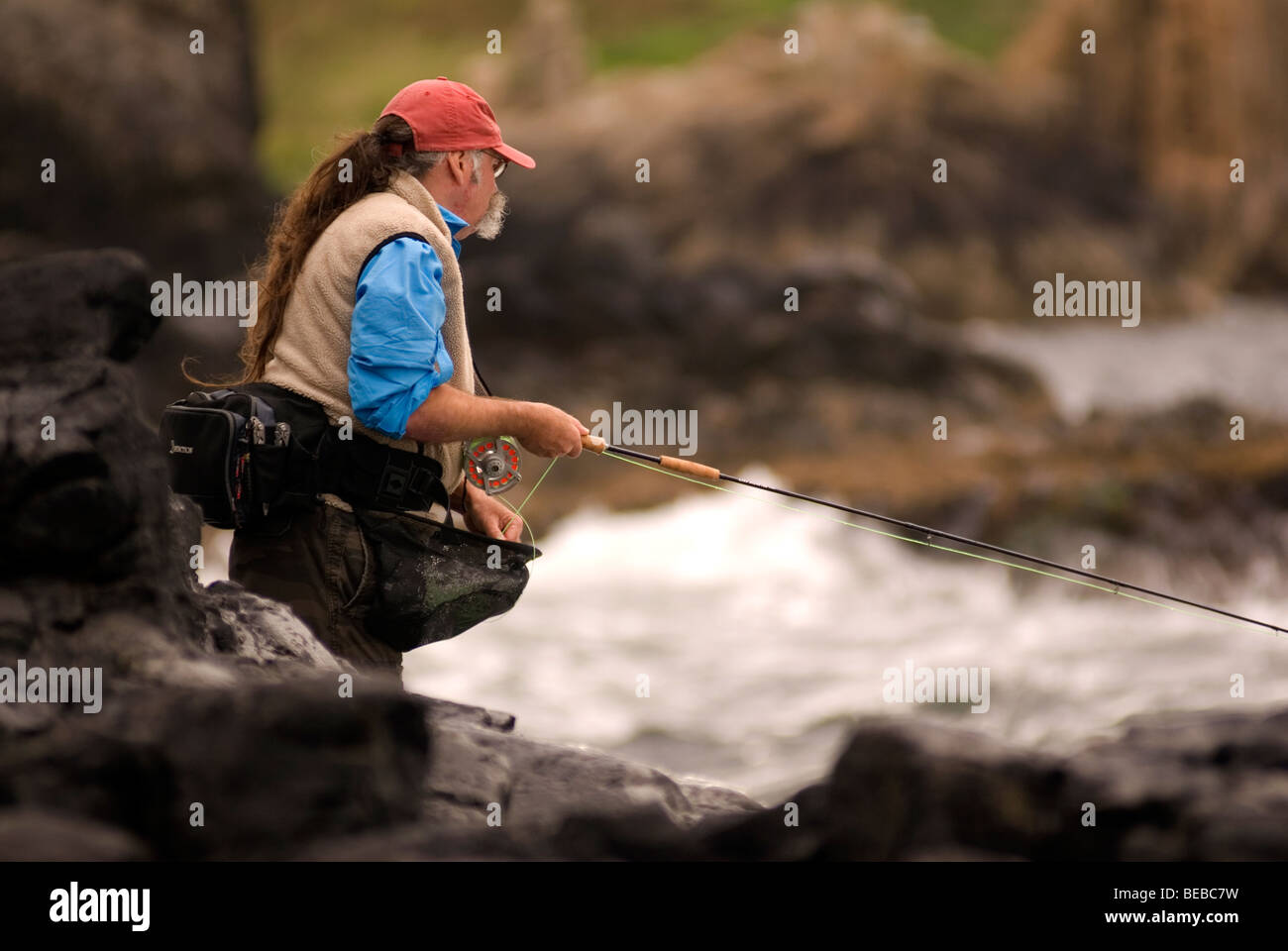 Fly fisherman Dave Felce casting a fly fishing rod into the sea off the