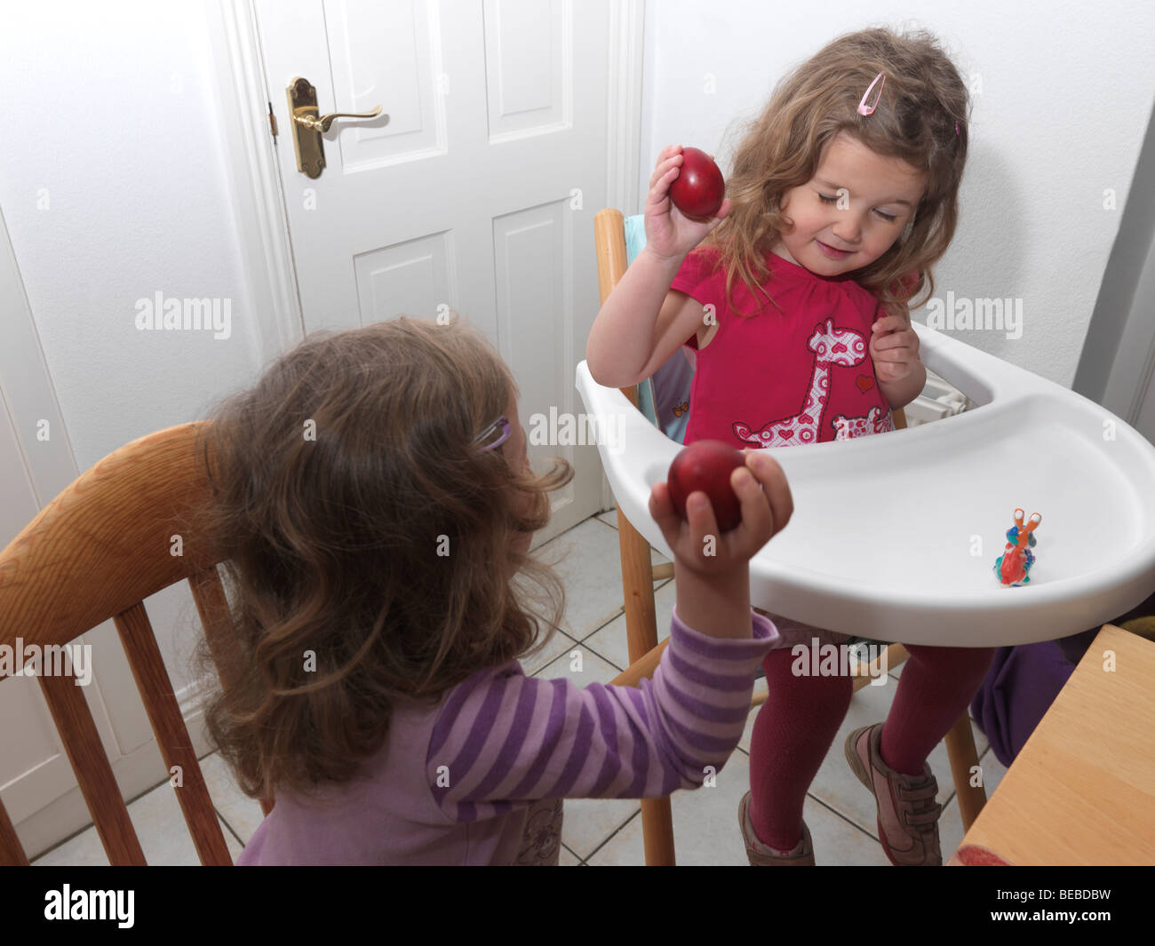 Cracking Red Eggs at Easter Stock Photo Alamy