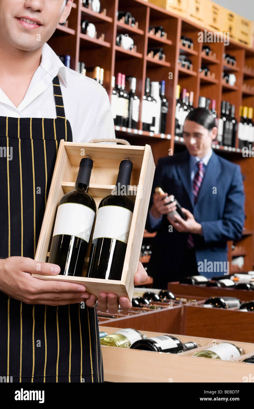 Two men holding up bottles hi-res stock photography and images - Alamy