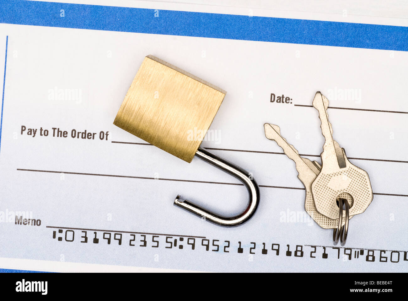 A lock on a blank check insinuating one should keep a close watch on their checking account and finances. Stock Photo