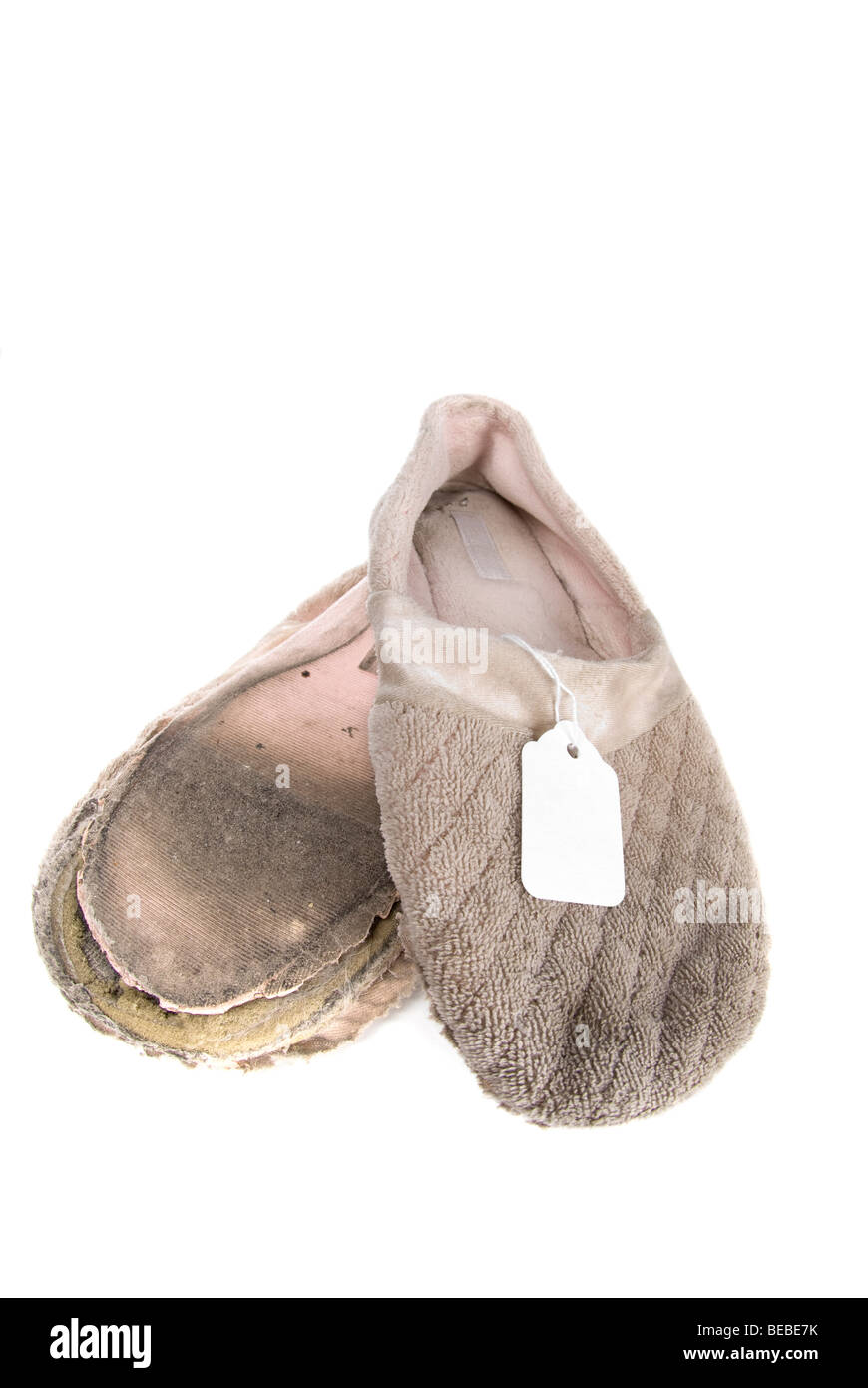 Old slippers with a price tag. Stock Photo