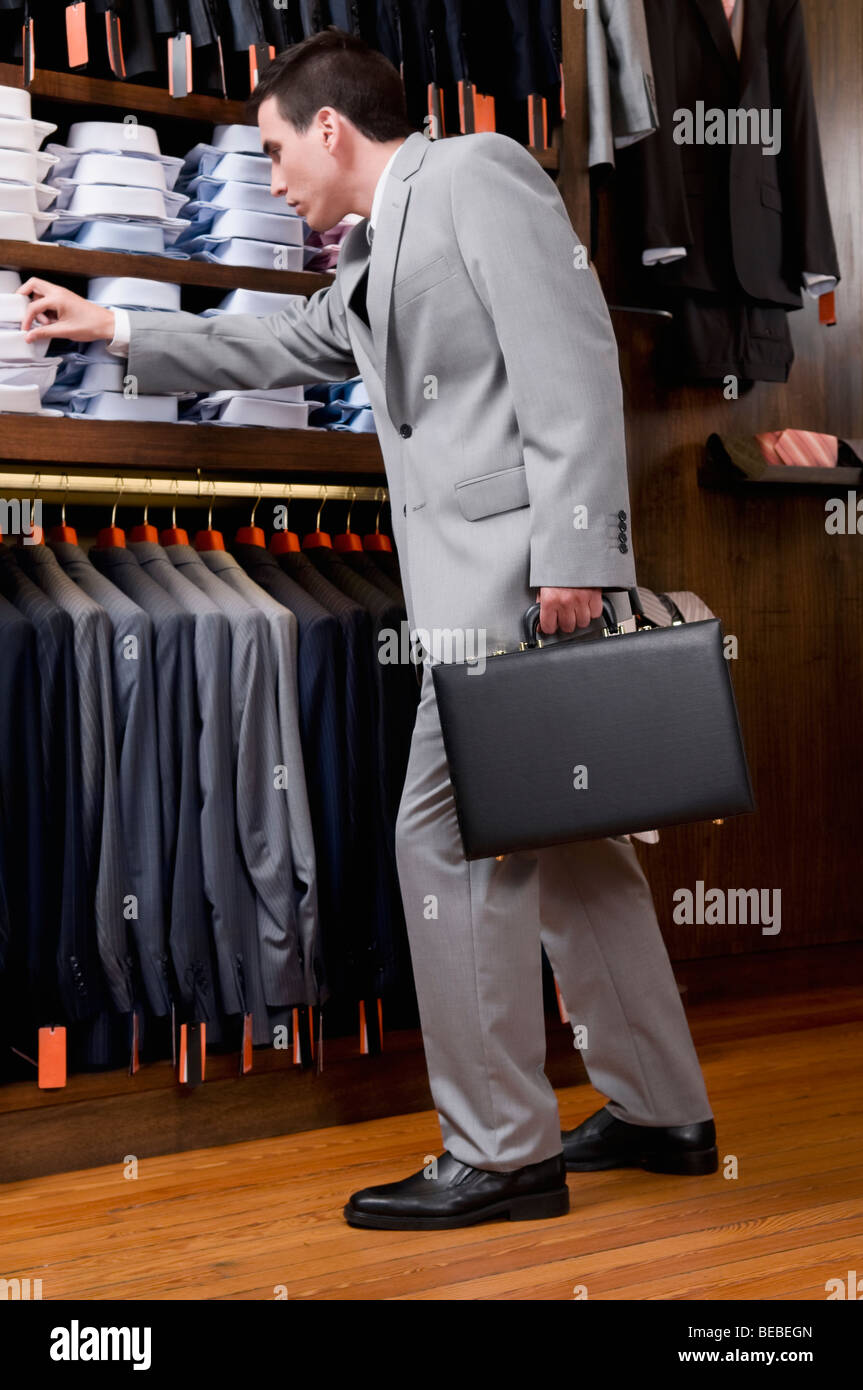 Man choosing shirts clothing store hi-res stock photography and images ...