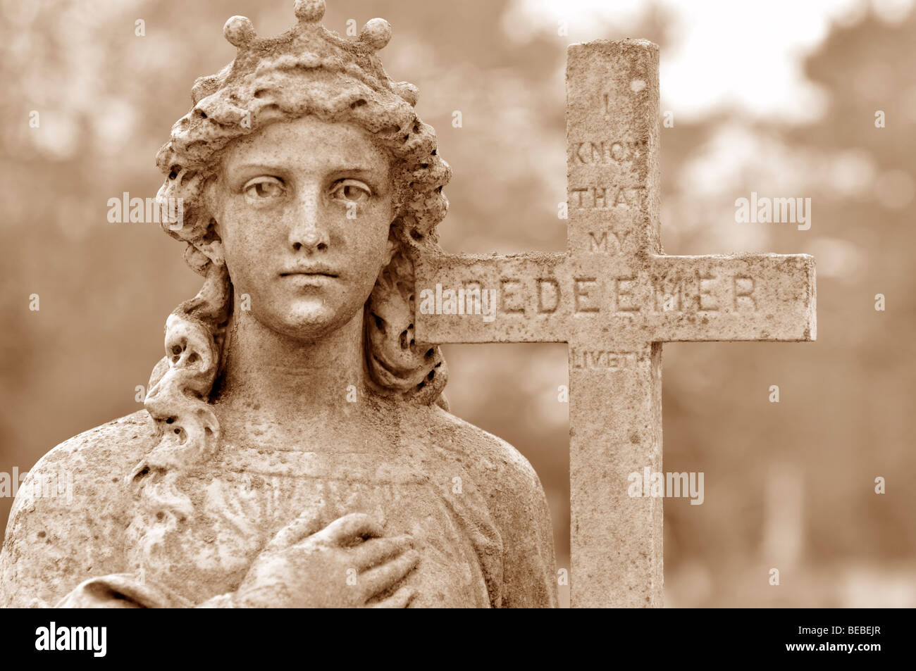 Old cemetery statue of woman holding cross of the Redeemer Stock Photo Alamy