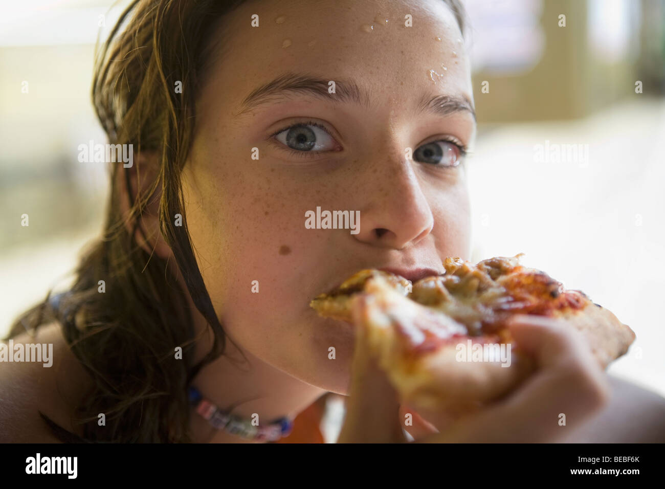 Portrait of a girl eating pizza Stock Photo