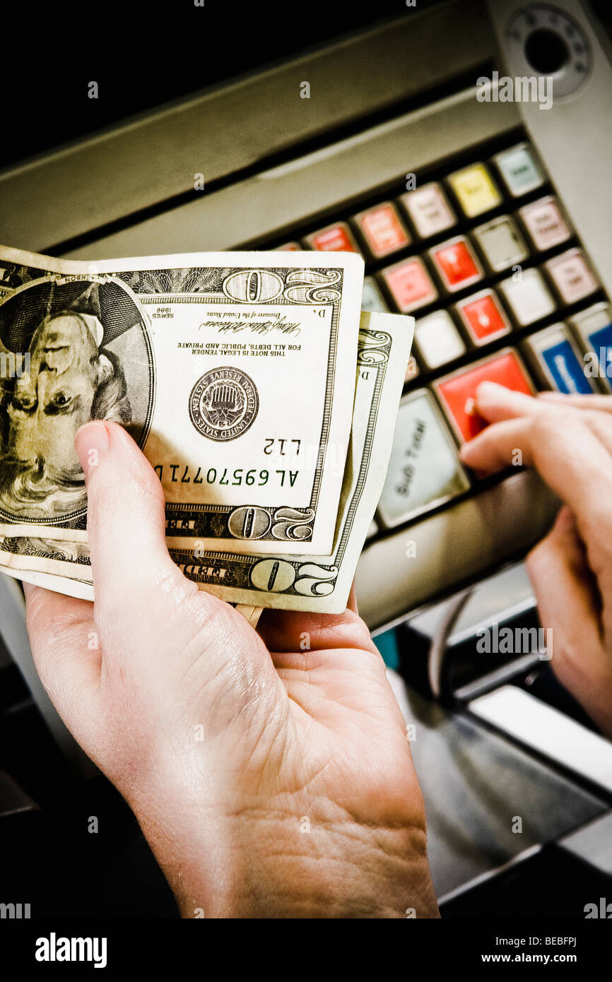 Sales clerk using a cash register at a checkout counter Stock Photo Alamy