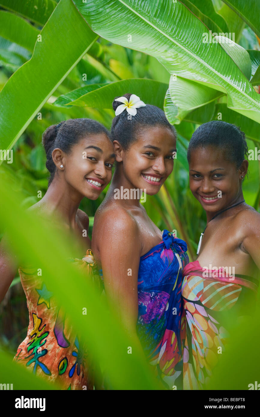 portrait-of-three-female-friends-enjoying-rain-BEBFT8.jpg