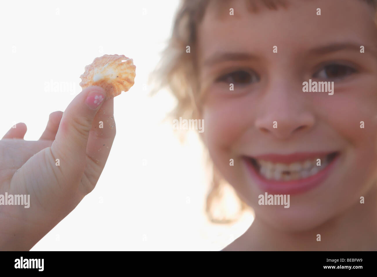 Portrait of a girl showing a seashell Stock Photo Alamy