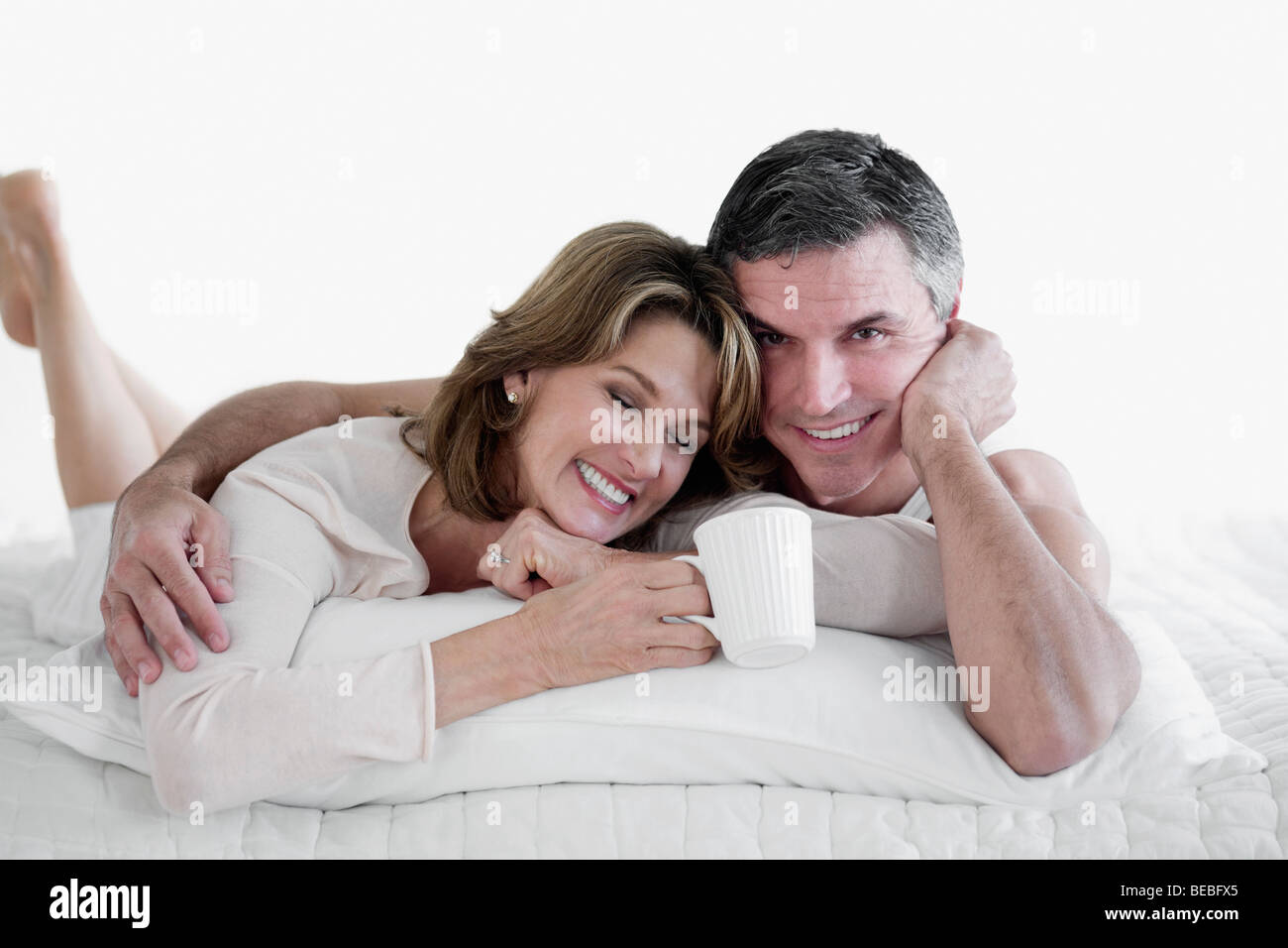 Couple lying on the bed and smiling Stock Photo