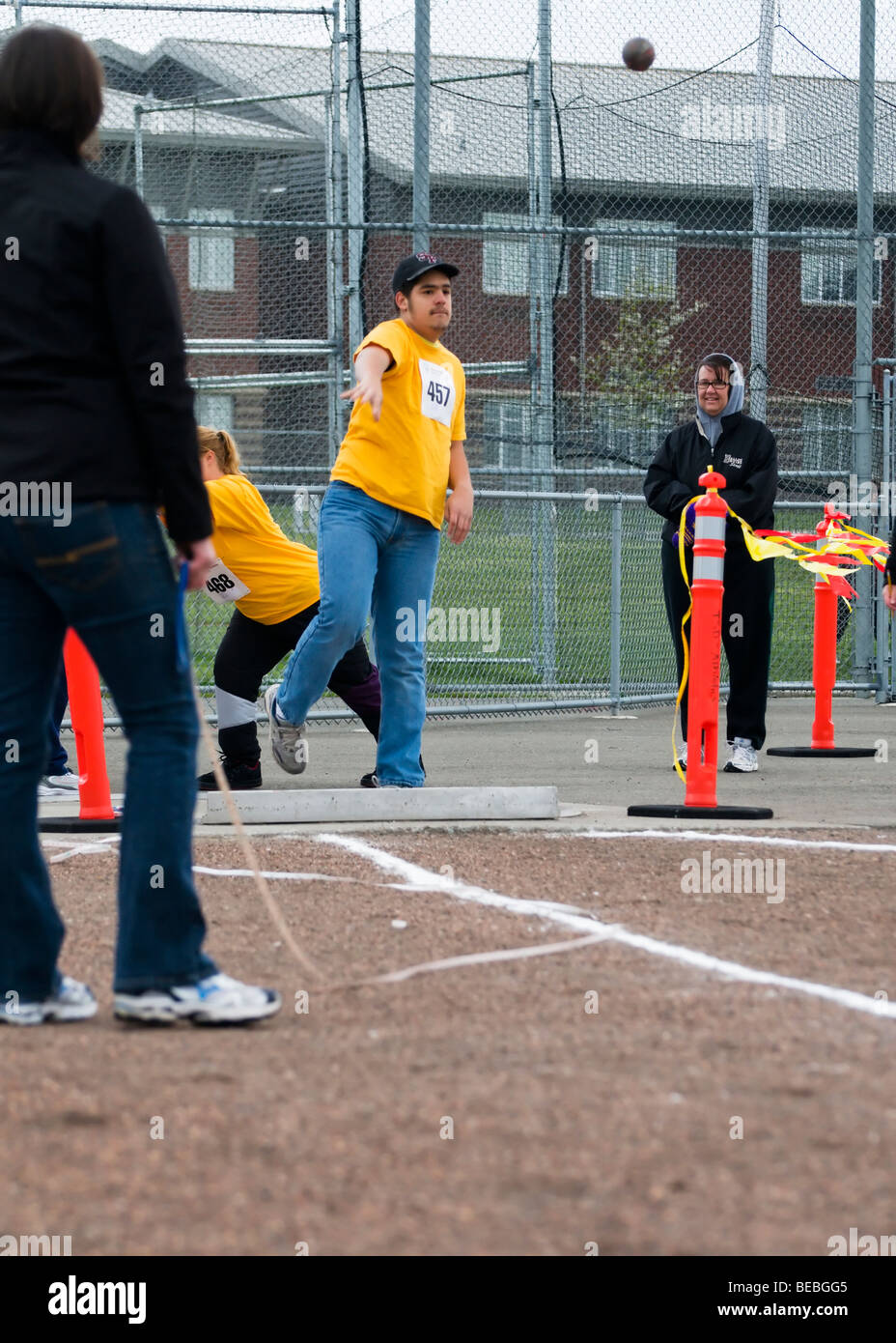 A young man throws a shot put during competition at the Special Olympics in Tacoma, Washington. Stock Photo