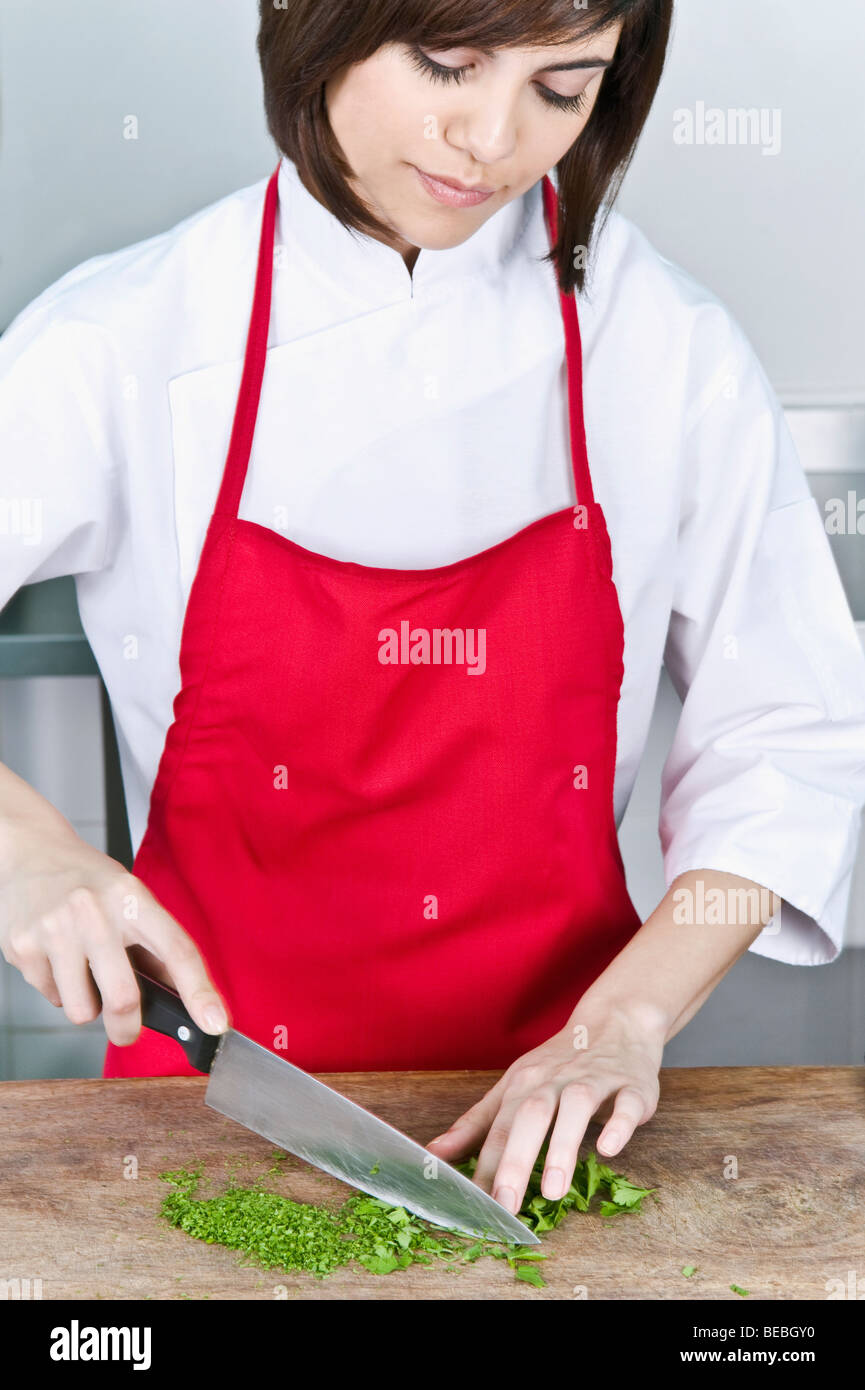 Female chef chopping cilantro leaves with a knife Stock Photo Alamy