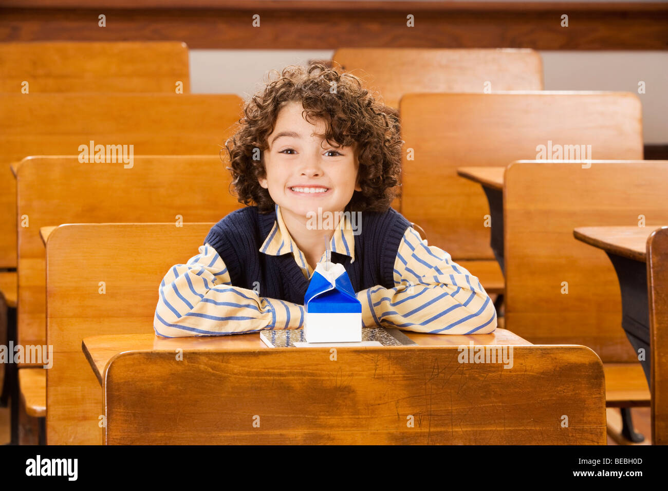 Schoolboy smiling in a classroom Stock Photo - Alamy