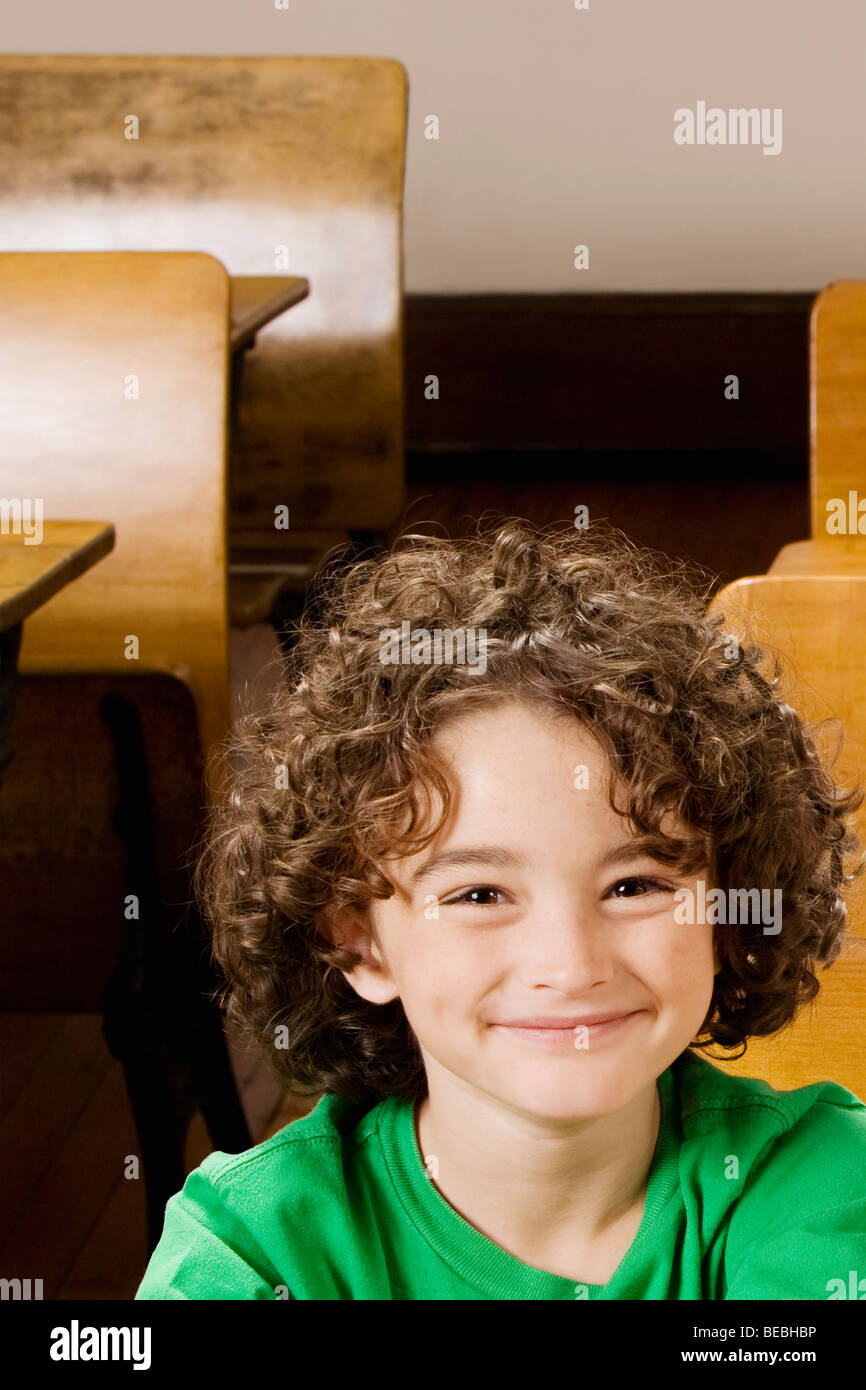 Portrait of a schoolboy smiling in a classroom Stock Photo - Alamy