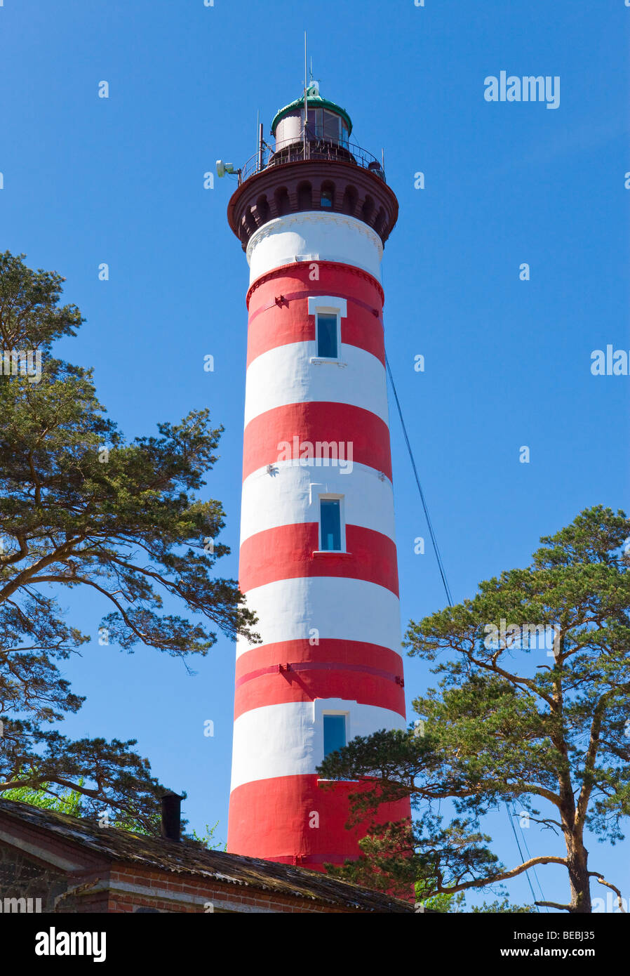Red-white Lighthouse on background of azure sky Stock Photo