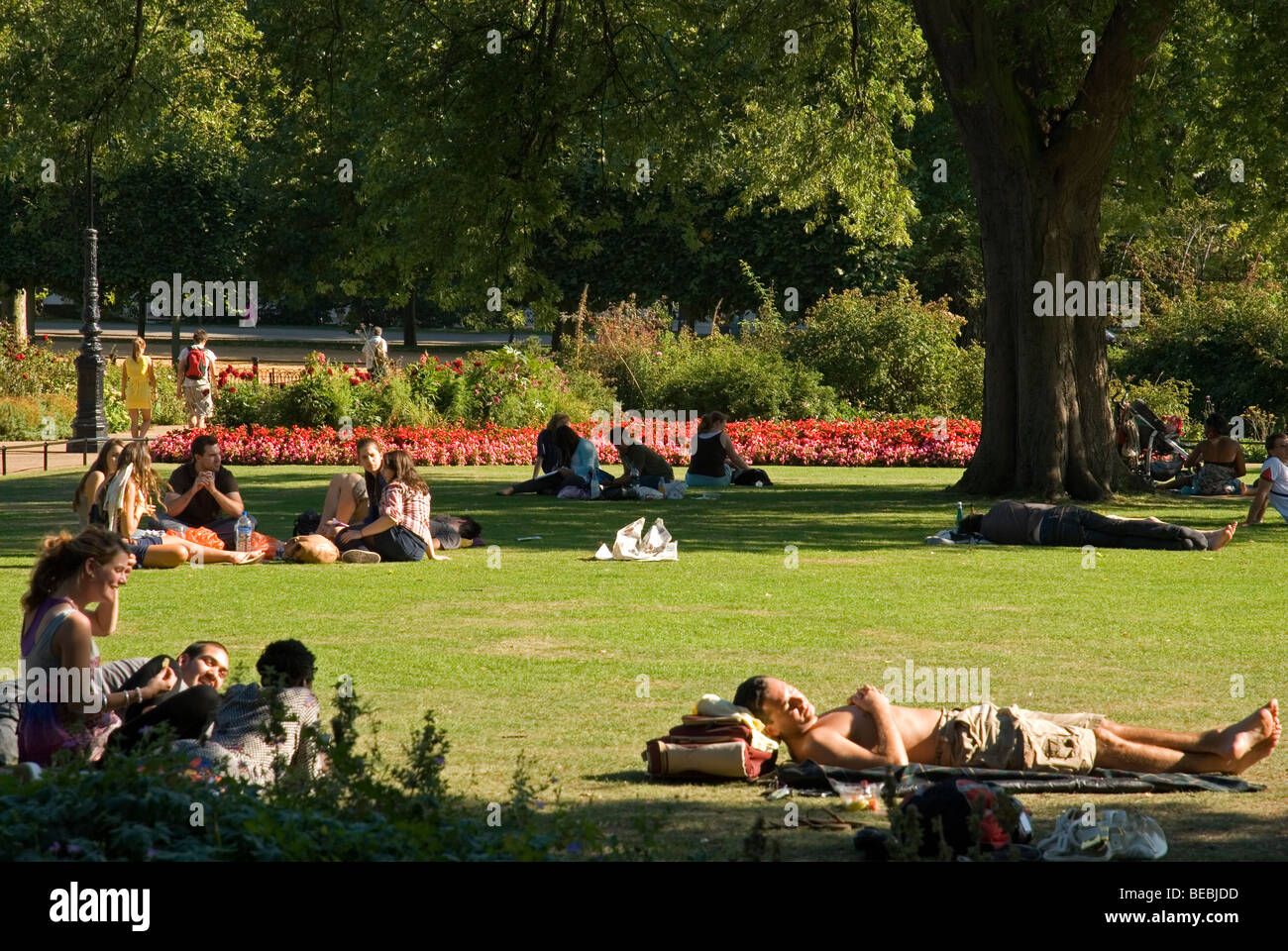 People relaxing on the grass on a sunny day in summer, Hyde Park London England UK Stock Photo