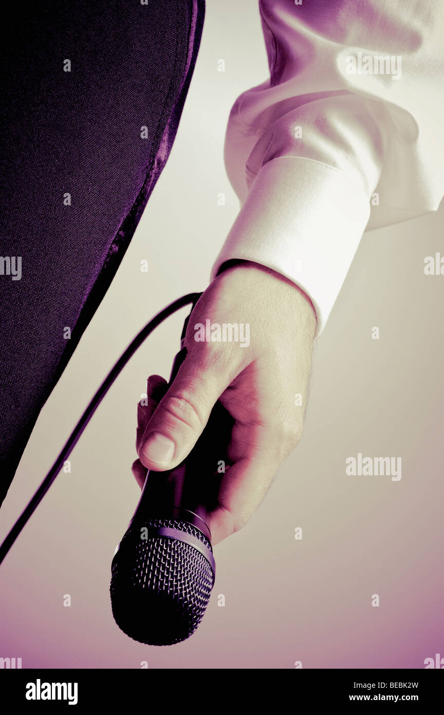 Close-up of a singer's hand holding a microphone Stock Photo - Alamy