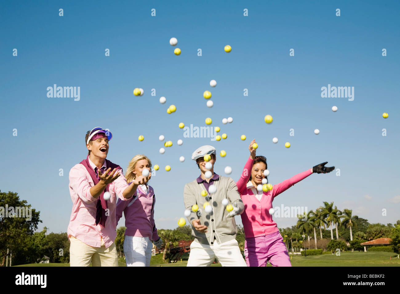 Four friends throwing golf balls in midair, Biltmore Golf Course