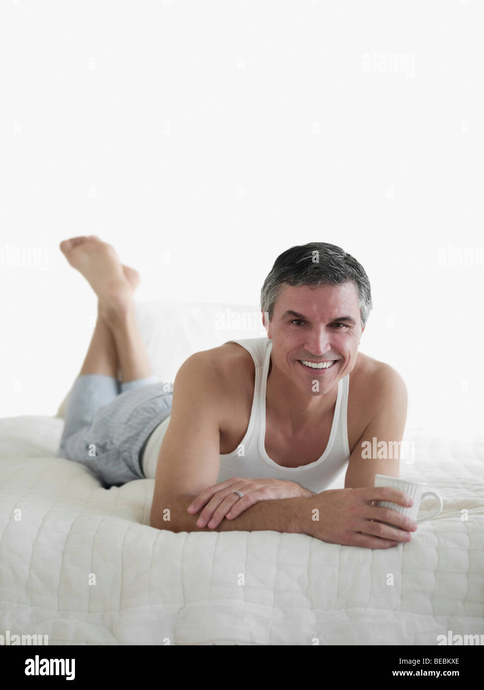 Man lying down feet up bed hires stock photography and images Alamy