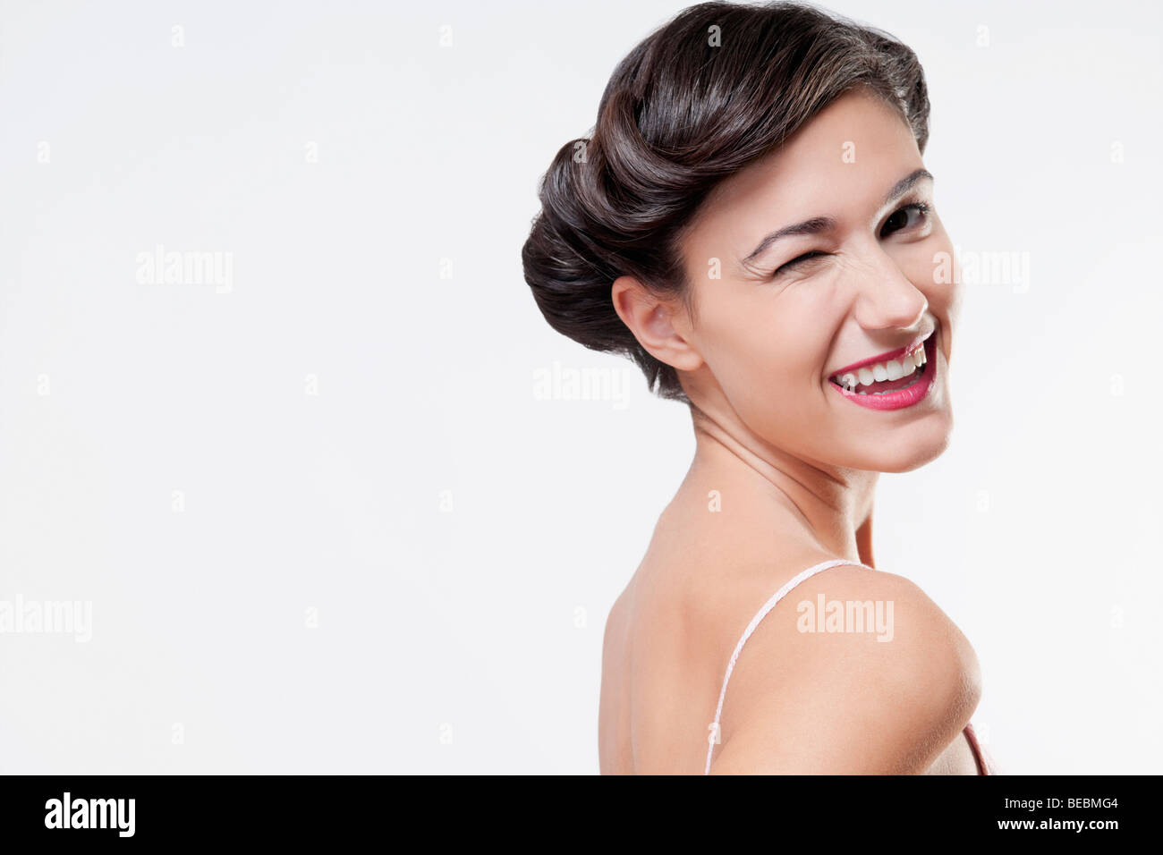 Close-up of a woman winking Stock Photo - Alamy