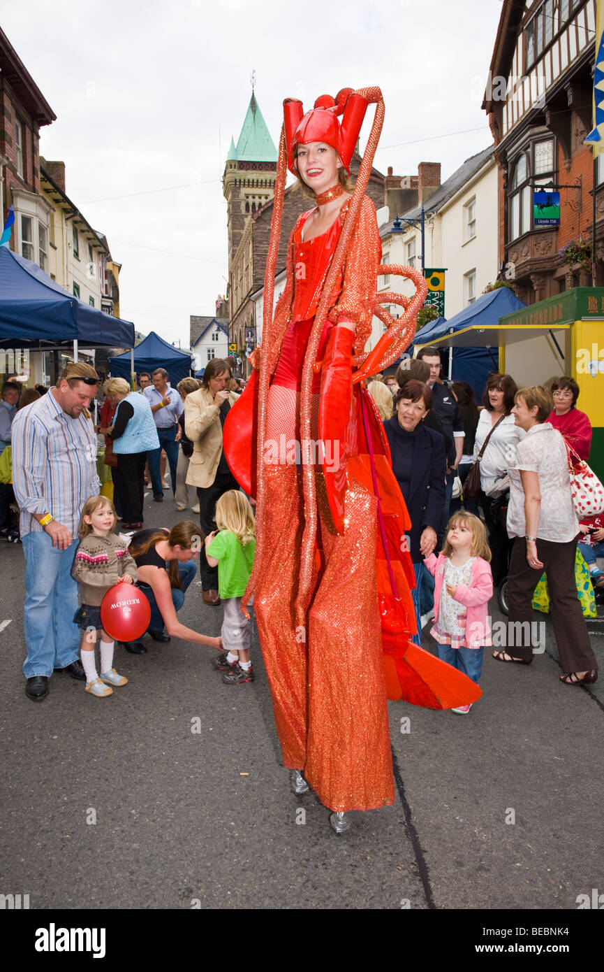 Stilt walking street performance artists dressed as lobsters at