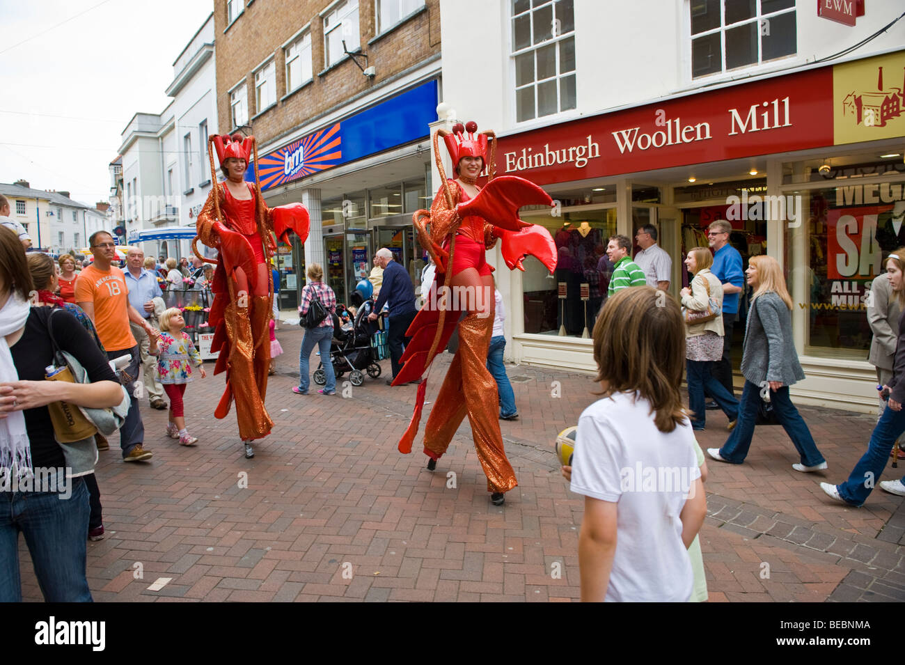 Stilt walking street performance artists dressed as lobsters at